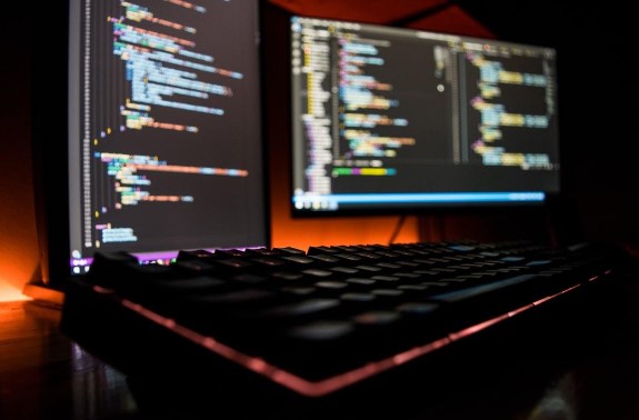 computer with programming code on the screen