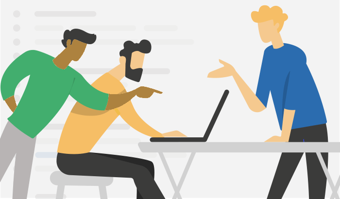 Programmers gathered around a laptop in a mob